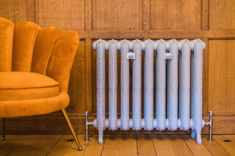 Ornate cast iron radiator by Castrads in Edwardian Country house painted in Little Greene colours